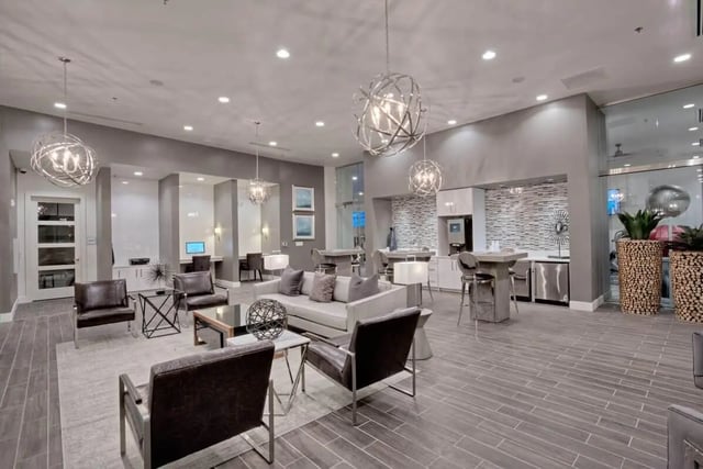 Modern lounge area with seating and kitchen living room at 101 Center in Arlington Student Accommodation