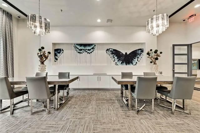 Dining tables chairs butterfly art common area at 101 Center in Arlington Student Accommodation