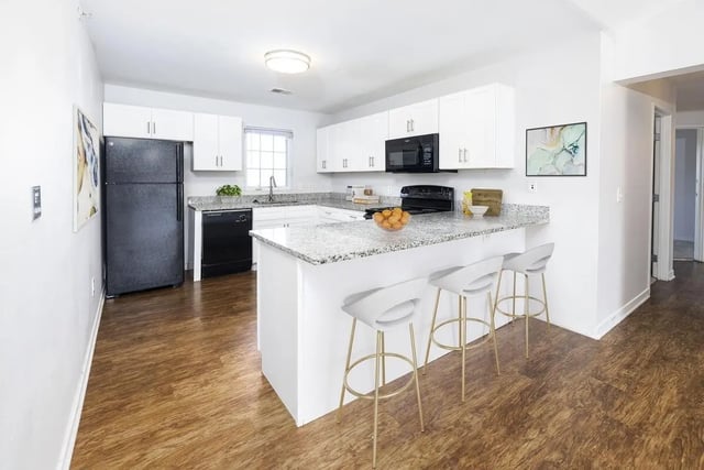 Modern kitchen with island and bar stools kitchen at The Tate on Howard in Kalamazoo Student Accommodation