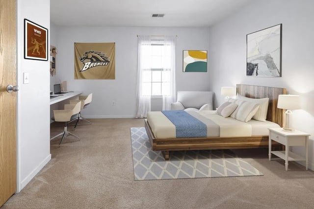 Bed with desk study area and Bronco flag bedroom at The Tate on Howard in Kalamazoo Student Accommodation