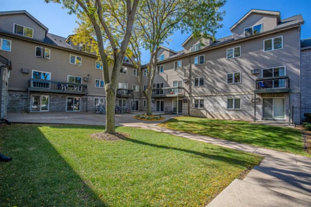 Apartment building with balconies and lawn exterior at College Park Apartments in Ithaca Student Accommodation