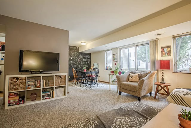 Television dining table chairs armchair living room at College Park Apartments in Ithaca Student Accommodation