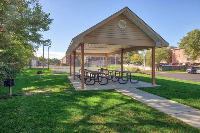 Covered picnic tables with grills outside amenity area at Launch Apartments in West Lafayette Student Accommodation