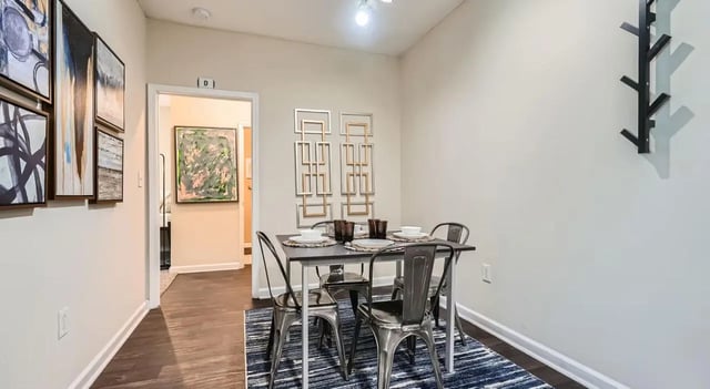 Dining table with chairs art on walls dining area at The Flats at Atlantic Station in Atlanta Student Accommodation