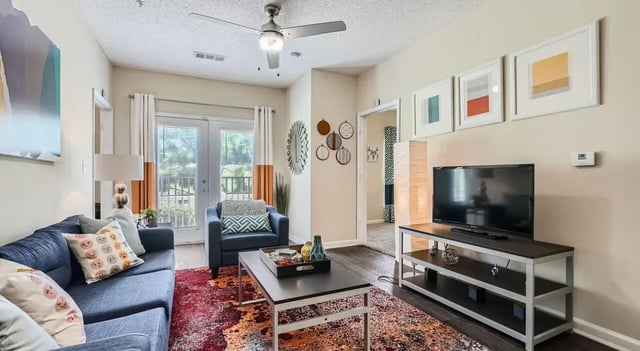 Sofa armchair coffee table TV living room at The Flats at Atlantic Station in Atlanta Student Accommodation