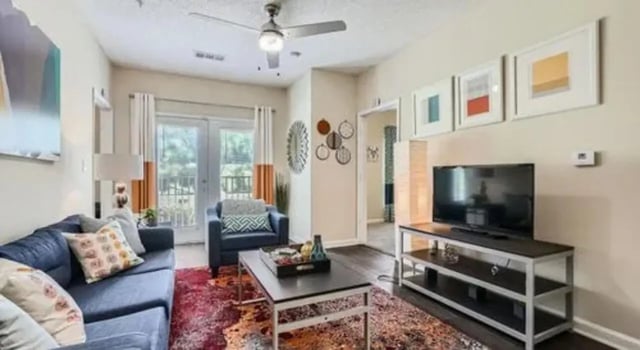 Sofa armchair coffee table TV living room at The Flats at Atlantic Station in Atlanta Student Accommodation