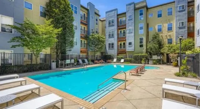 Pool with lounge chairs and buildings exterior at The Flats at Atlantic Station in Atlanta Student Accommodation