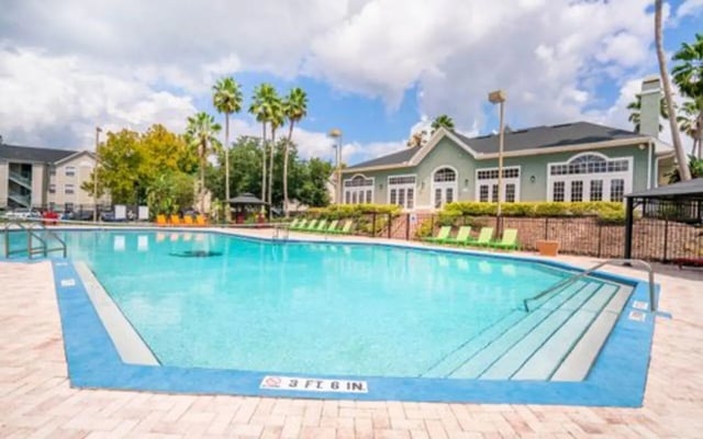 Large swimming pool with lounge chairs exterior at The Pointe at Central in Orlando Student Accommodation