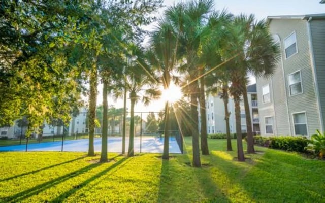 Apartment buildings with palm trees and tennis court exterior at The Pointe at Central in Orlando Student Accommodation
