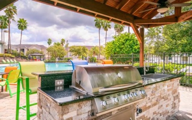 Grill sink chairs and pool exterior at The Pointe at Central in Orlando Student Accommodation