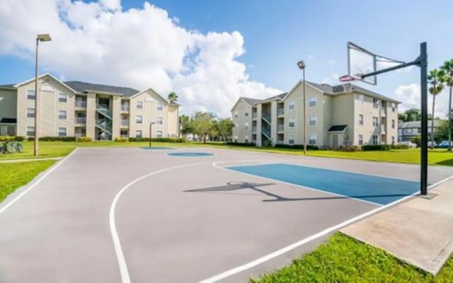 Basketball court with apartment buildings exterior at The Pointe at Central in Orlando Student Accommodation