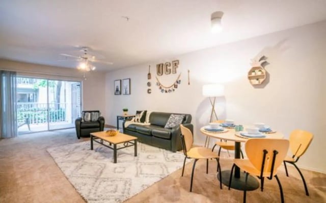 Sofa table chairs rug and dining set living room at The Pointe at Central in Orlando Student Accommodation