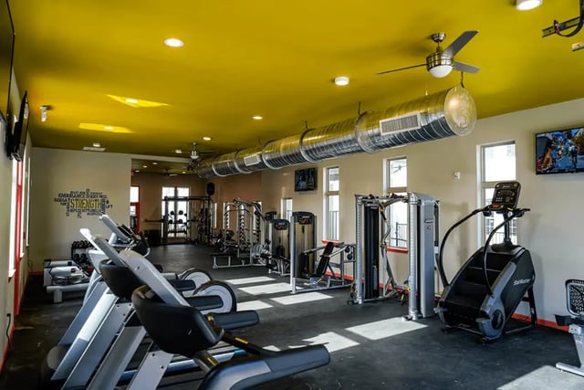 Treadmills stair climber weight machines gym at The Pointe at Pinhook in Lafayette Student Accommodation