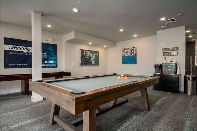 Pool table shuffleboard coffee station game room at The Rocks in East Lansing Student Accommodation