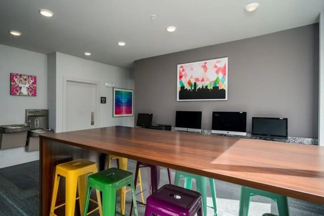 Computers and stools at communal table study area at The Rocks in East Lansing Student Accommodation