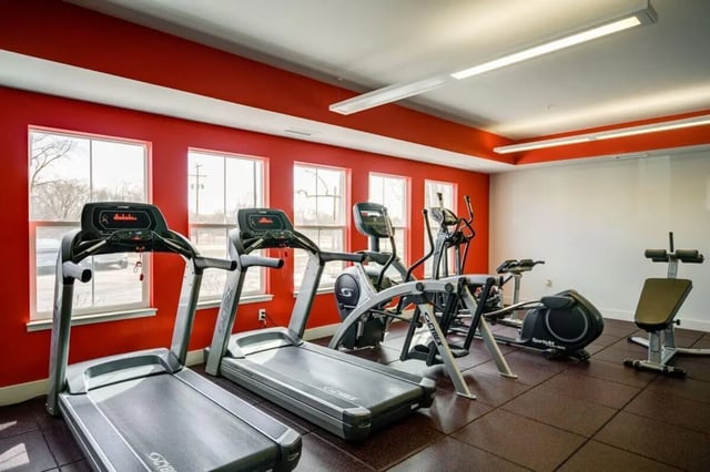 Treadmills elliptical and weight bench gym at The Rocks in East Lansing Student Accommodation
