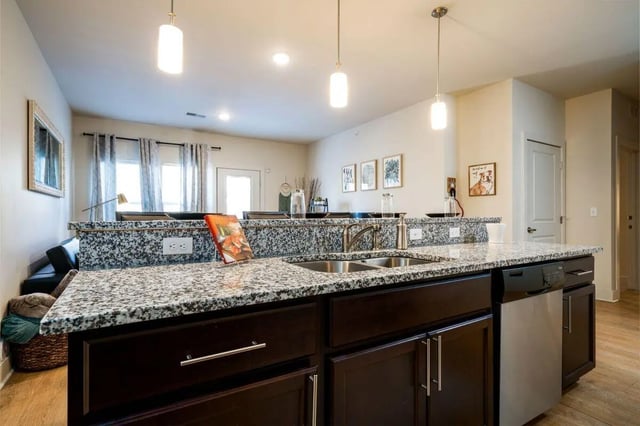 Granite countertop double sink pendant lights kitchen at The Rocks in East Lansing Student Accommodation