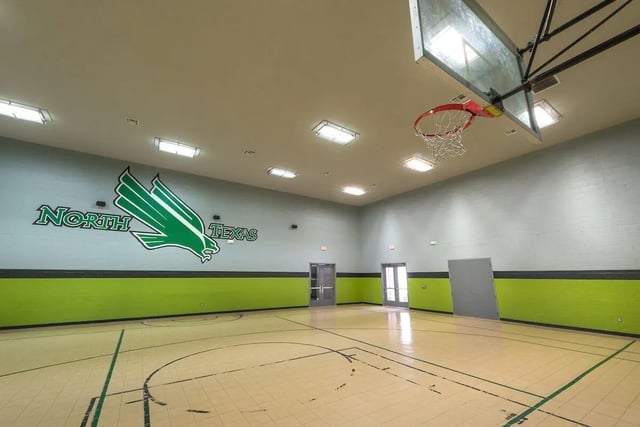 Basketball court with North Texas logo playing area exterior at Forum at Denton Station in Denton Student Accommodation