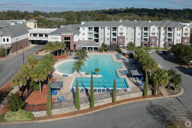 Apartment complex with pool and lounge chairs exterior at Forum at Tallahassee in Tallahassee Student Accommodation