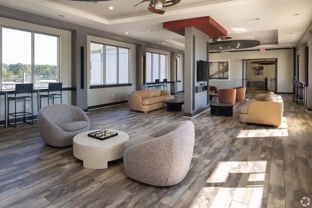 Sofas chairs coffee tables and tic tac toe game lounge at Forum at Tallahassee in Tallahassee Student Accommodation