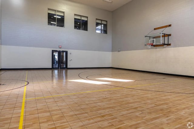 Indoor basketball court with hoop and court lines playing area at Forum at Tallahassee in Tallahassee Student Accommodation