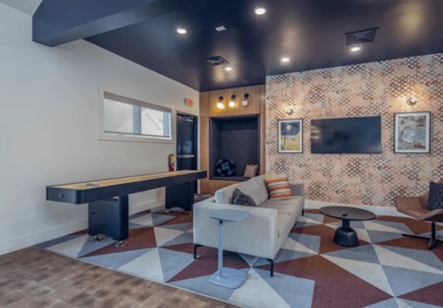 Shuffleboard couch and TVs communal living room at The Roost in Columbia Student Accommodation