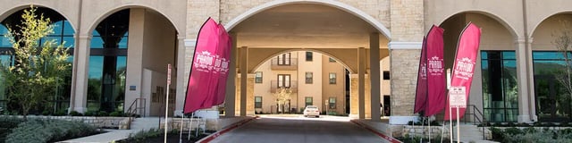 Flags archways and a car exterior at Prado Student Living in San Antonio Student Accommodation