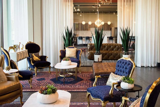 Ornate chairs plush sofa plants living room at Prado Student Living in San Antonio Student Accommodation