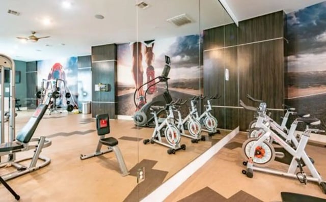 Weight machines exercise bikes mirrored wall fitness center at The Icon & Lofts at the Icon in Houston Student Accommodation