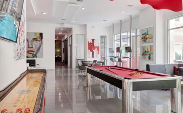 Shuffleboard table pool table gaming area living room at The Icon & Lofts at the Icon in Houston Student Accommodation