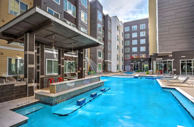 Pool with lounge chairs and seating area exterior at The Icon & Lofts at the Icon in Houston Student Accommodation
