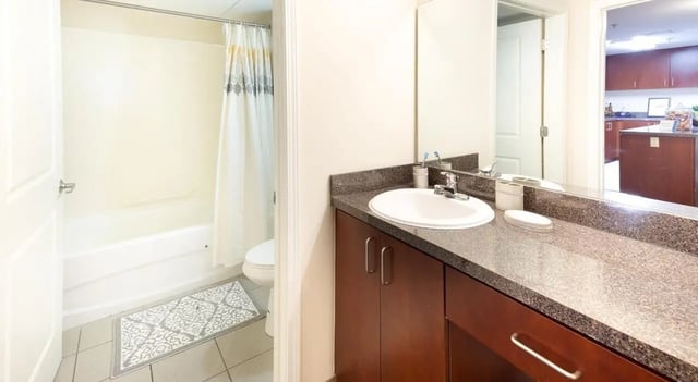 Sink shower tub toilet rug bathroom at 100 Midtown in Atlanta Student Accommodation