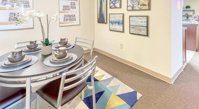 Round dining table set with four chairs dining area at 100 Midtown in Atlanta Student Accommodation