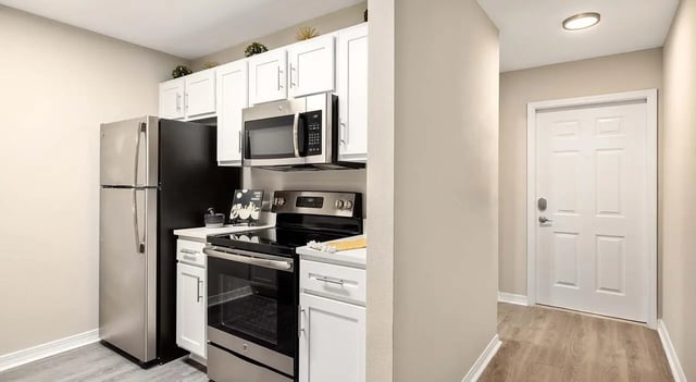 Refrigerator stove microwave white cabinets kitchen at 403 West in Raleigh Student Accommodation
