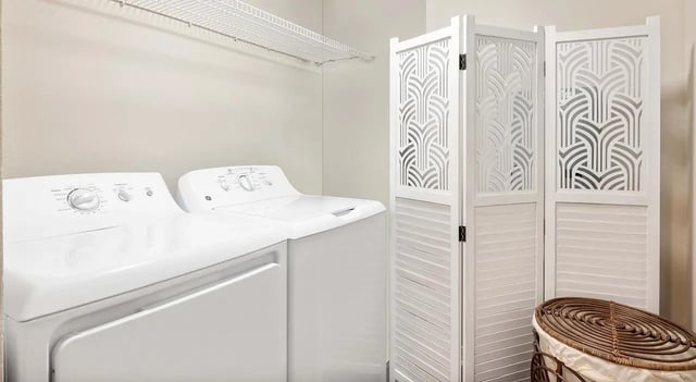 White washer dryer and decorative screen laundry room at 403 West in Raleigh Student Accommodation