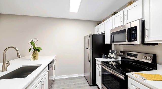 White cabinets stainless steel appliances kitchen at 403 West in Raleigh Student Accommodation