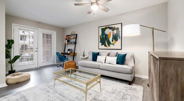 Sofa coffee table desk and plant living room at 403 West in Raleigh Student Accommodation