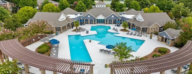 Swimming pool with lounge chairs and buildings exterior at 403 West in Raleigh Student Accommodation