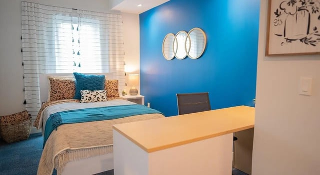 Bed with leopard pillows and desk Image Type Bedroom at Cheatham Street Flats in San Marcos Student Accommodation