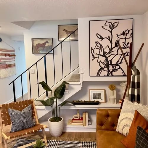 Chair plant artwork and stairs living room at The Den Cedar Ridge in Willington Student Accommodation