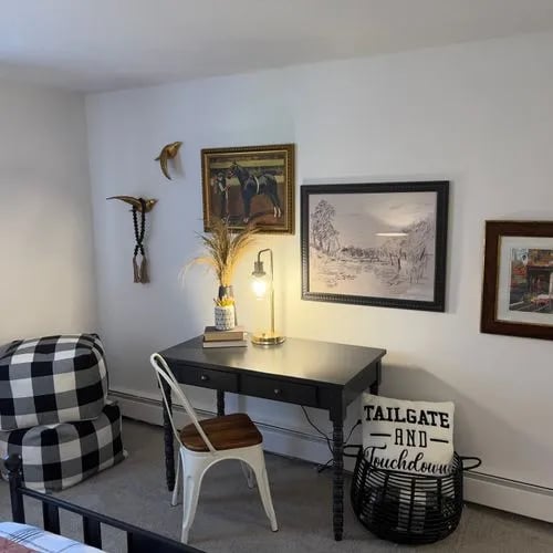 Desk lamp chair and artwork study area at The Den Cedar Ridge in Willington Student Accommodation