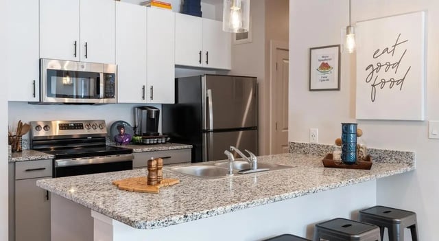 Modern kitchen with stainless steel appliances and island kitchen at The Vanguard in Cincinnati Student Accommodation