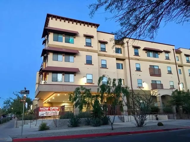 Modern beige apartment building with balconies exterior at The Junction At Iron Horse Student Housing in Tucson Student Accommodation