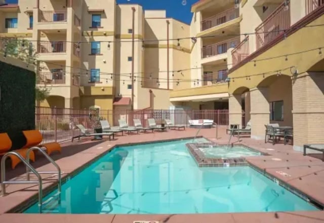 Swimming pool and hot tub with lounge chairs exterior at The Junction At Iron Horse Student Housing in Tucson Student Accommodation