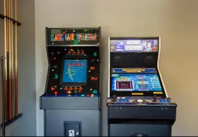 Two arcade games with pool cues Playing area at The Junction At Iron Horse Student Housing in Tucson Student Accommodation