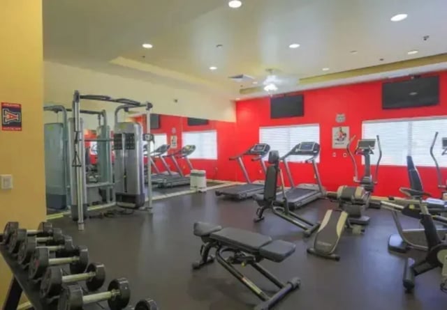Dumbbells treadmills weight machines gym. at The Junction At Iron Horse Student Housing in Tucson Student Accommodation