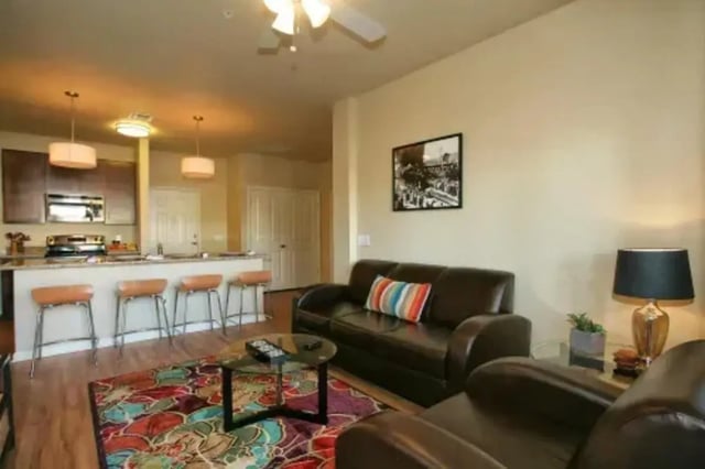 Sofa bar stools coffee table kitchen living room at The Junction At Iron Horse Student Housing in Tucson Student Accommodation