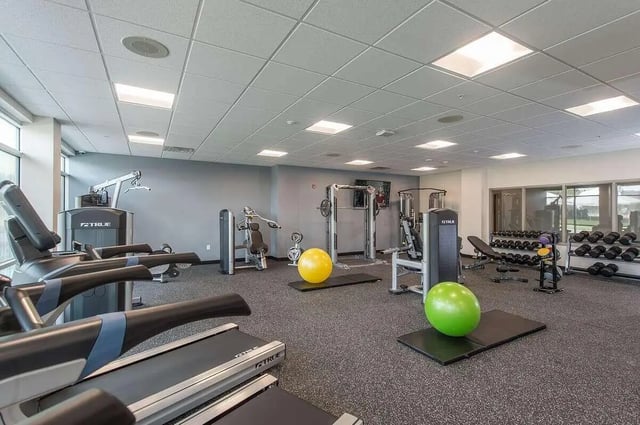 Treadmills weight machines yellow green balls gym at Campus Walk Apartments in Buffalo Student Accommodation