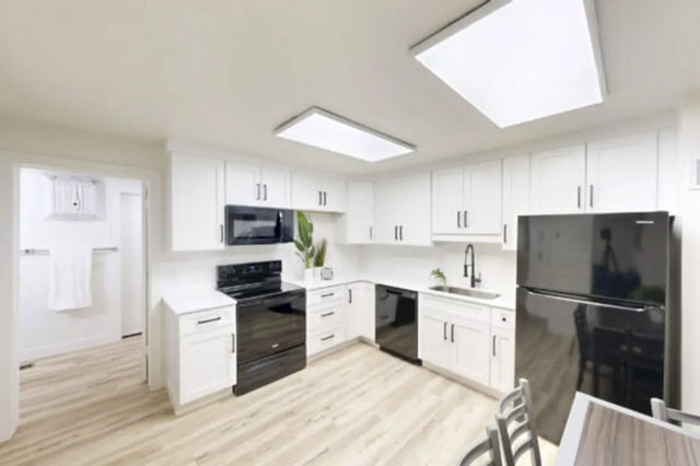 White cabinets black appliances modern kitchen and dining area at Bountiful Court Apartments in Provo Student Accommodation