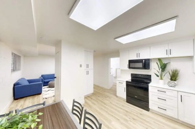 Blue sofas and kitchen appliances living room at Bountiful Court Apartments in Provo Student Accommodation